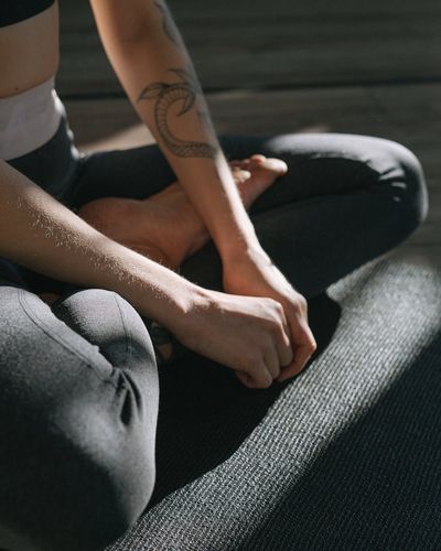 Close-up of a person's hands in a meditative pose.